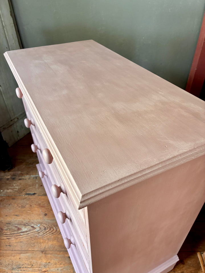 Top view of Soft Pink Chest of Drawers showcasing handpainted wooden finish and elegant design details.