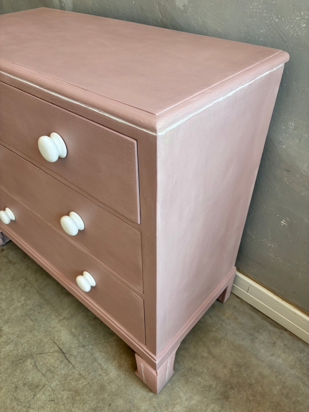 Pink Chest of Drawers with Porcelain Handles featuring white porcelain handles and a soft earthy pink finish.
