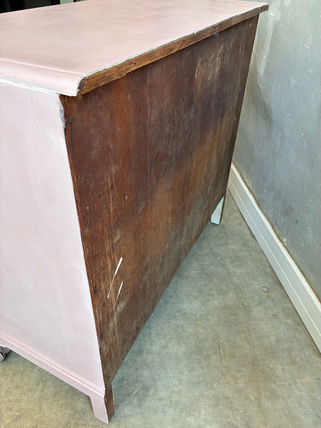Pink Chest of Drawers with Porcelain Handles showcasing the vintage wood finish and soft pink color.