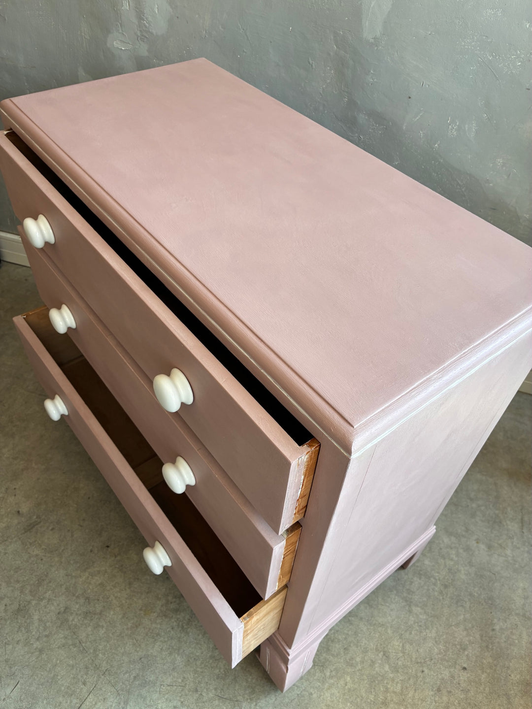 Pink Chest of Drawers with Porcelain Handles displayed at Source for the Goose, Devon.
