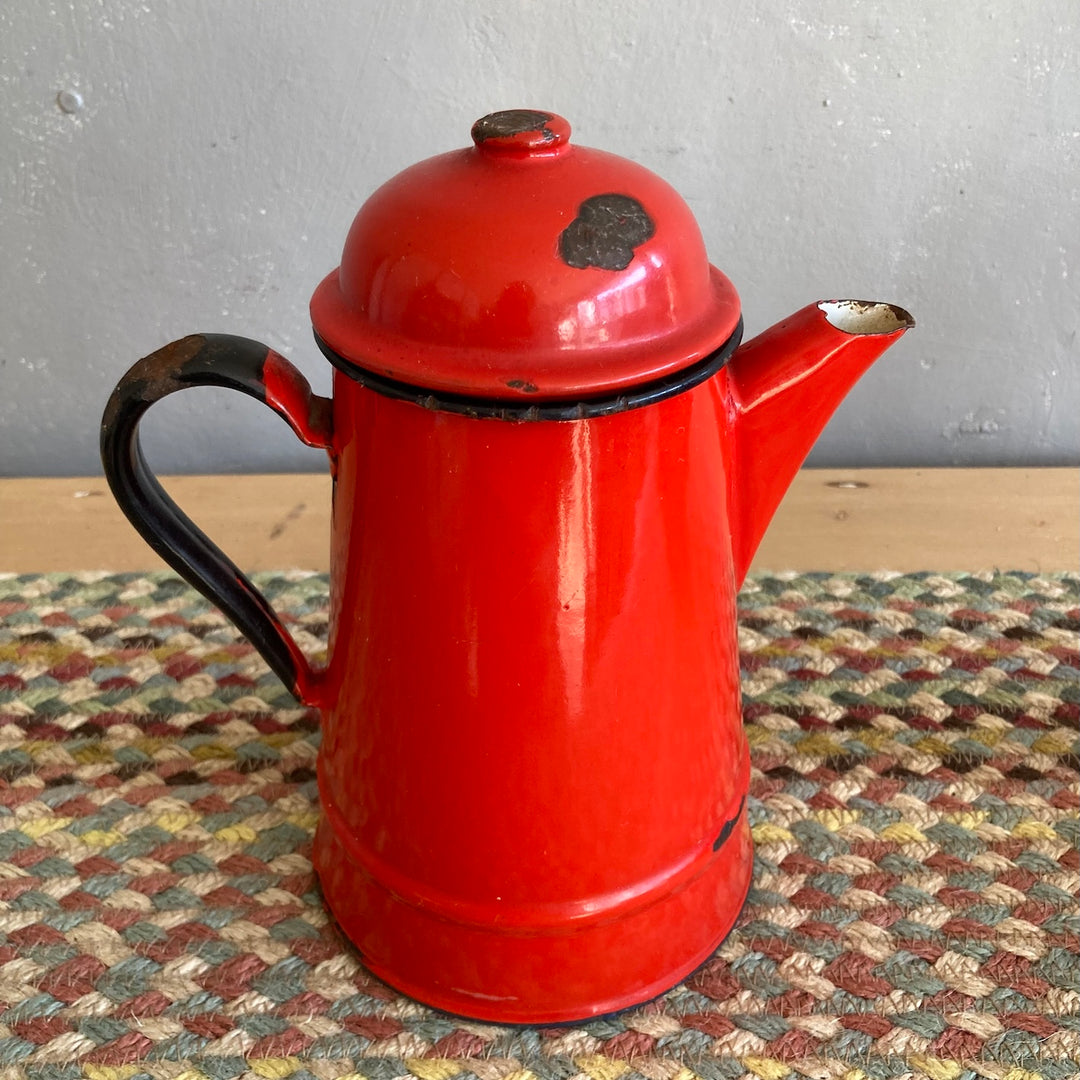 Vintage red enamel teapot with rustic charm, perfect for country kitchens. Source for the Goose, Devon.