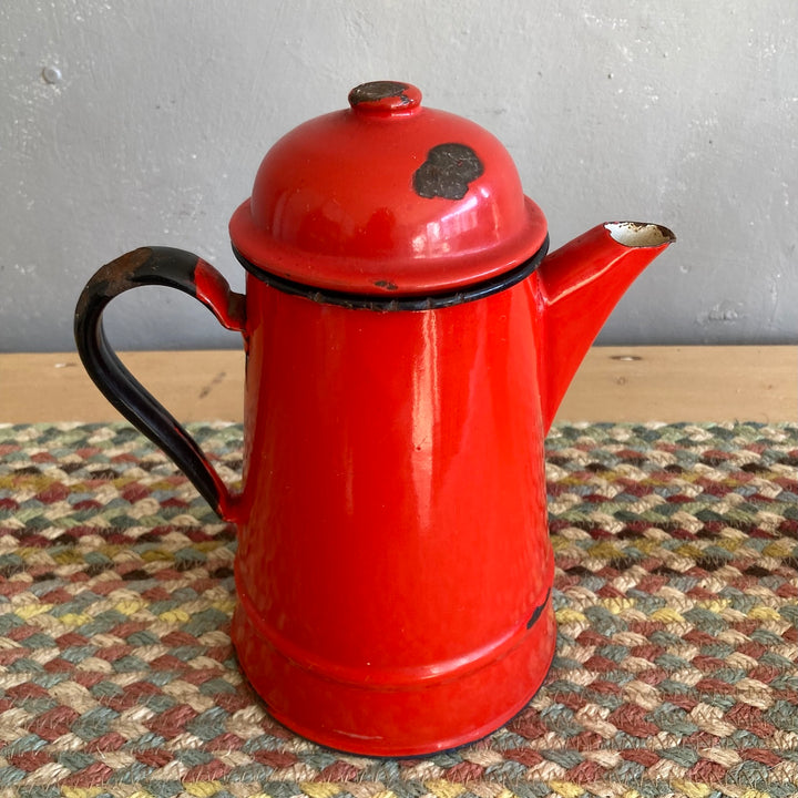 Vintage red enamel teapot with rustic charm, perfect for country kitchens. Source for the Goose, Devon.