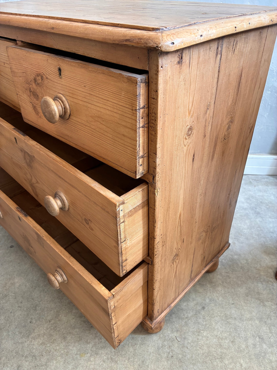 Rustic antique pine chest of drawers with original knobs, showcasing a vintage design and warm, waxed finish from Source for the Goose Devon.