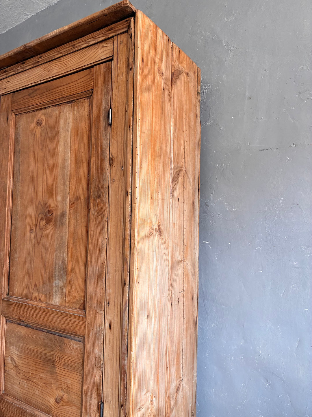 Tall Rustic Pine Housekeepers Cupboard corner view showing the rich wood grain and rustic charm of the cupboard.
