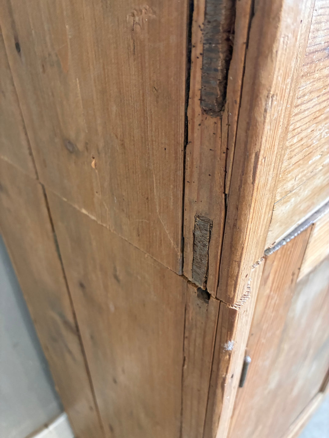 Close-up of the aged wood detail on the Tall Rustic Pine Housekeepers Cupboard from Source for the Goose, Devon.