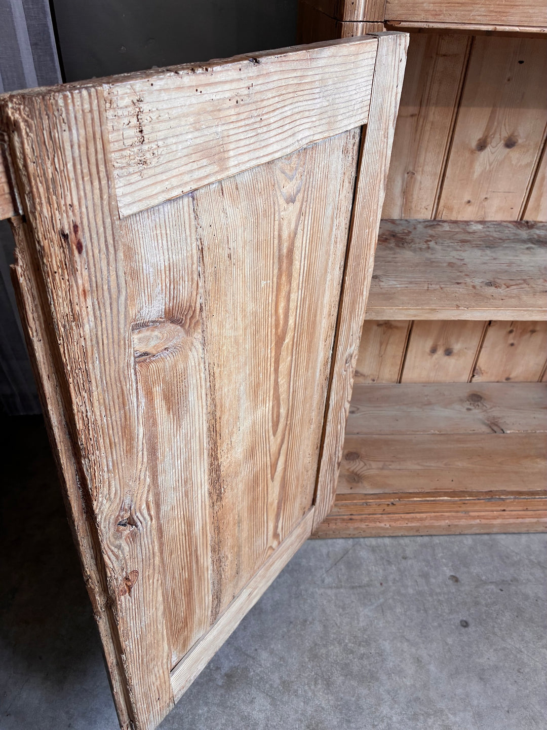 Tall Rustic Pine Housekeepers Cupboard with rustic wooden door detail showcasing aged pine and country charm.
