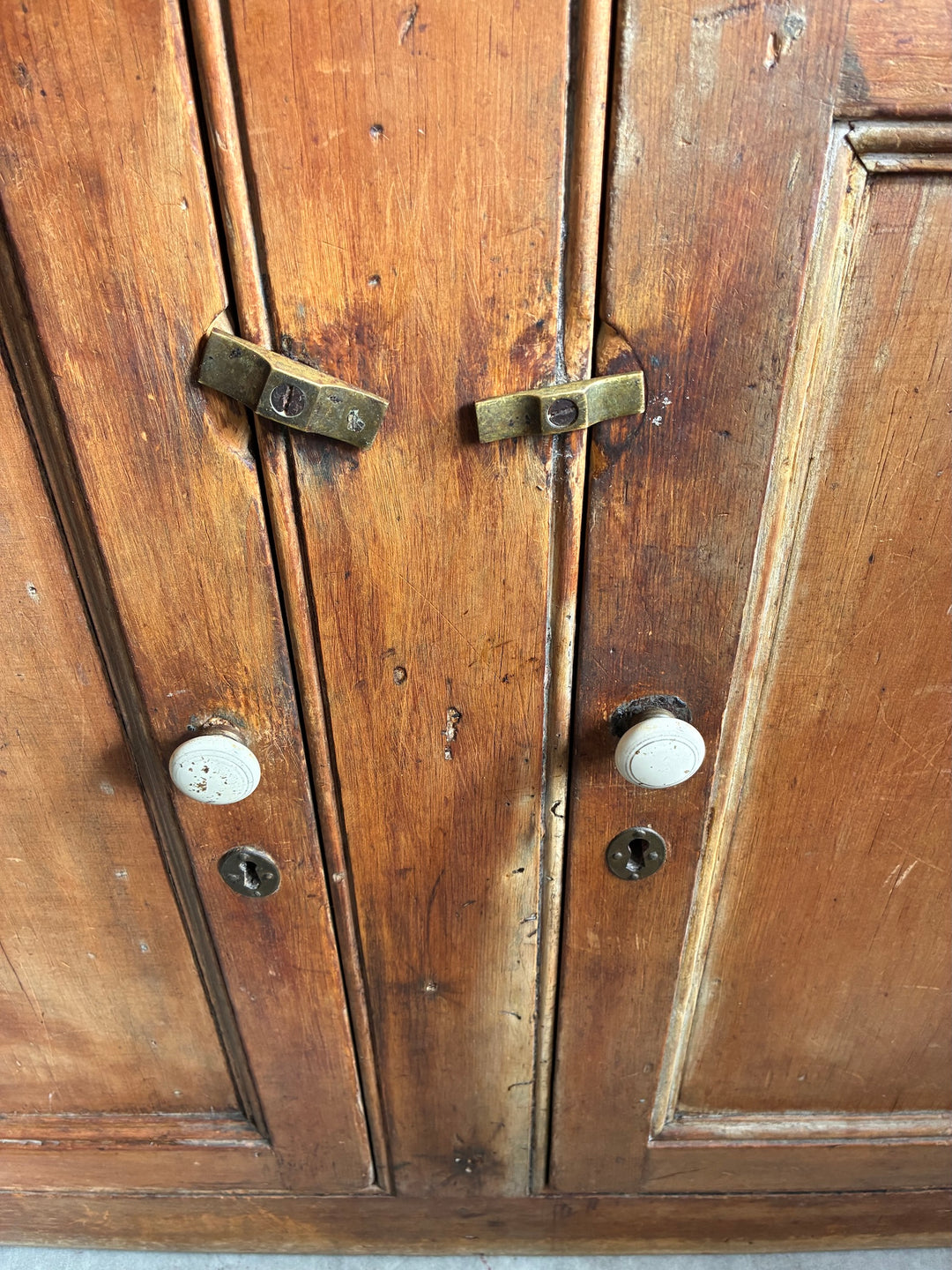 Close-up of the handles and locks on the Rustic Antique Pine Dresser, showcasing its vintage character and craftsmanship.