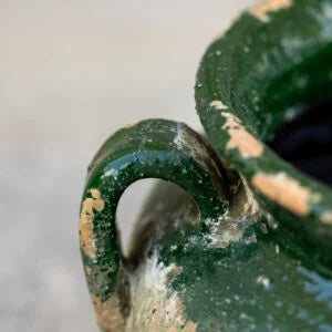 Close-up of rustic green glazed vase showcasing its weathered design, perfect for home decor from Source for the Goose, Devon.
