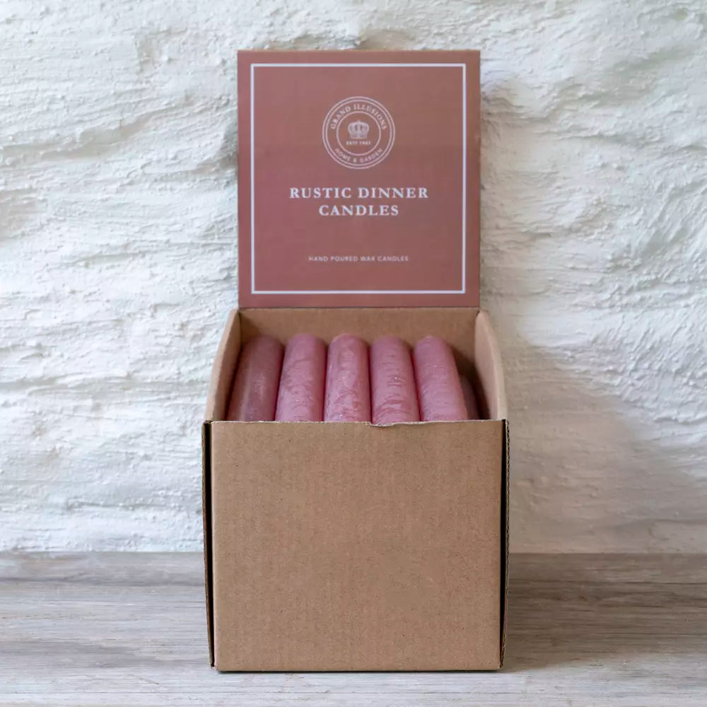 Set of Three Rustic Dusky Pink Dinner Candles in a box on a wooden surface.