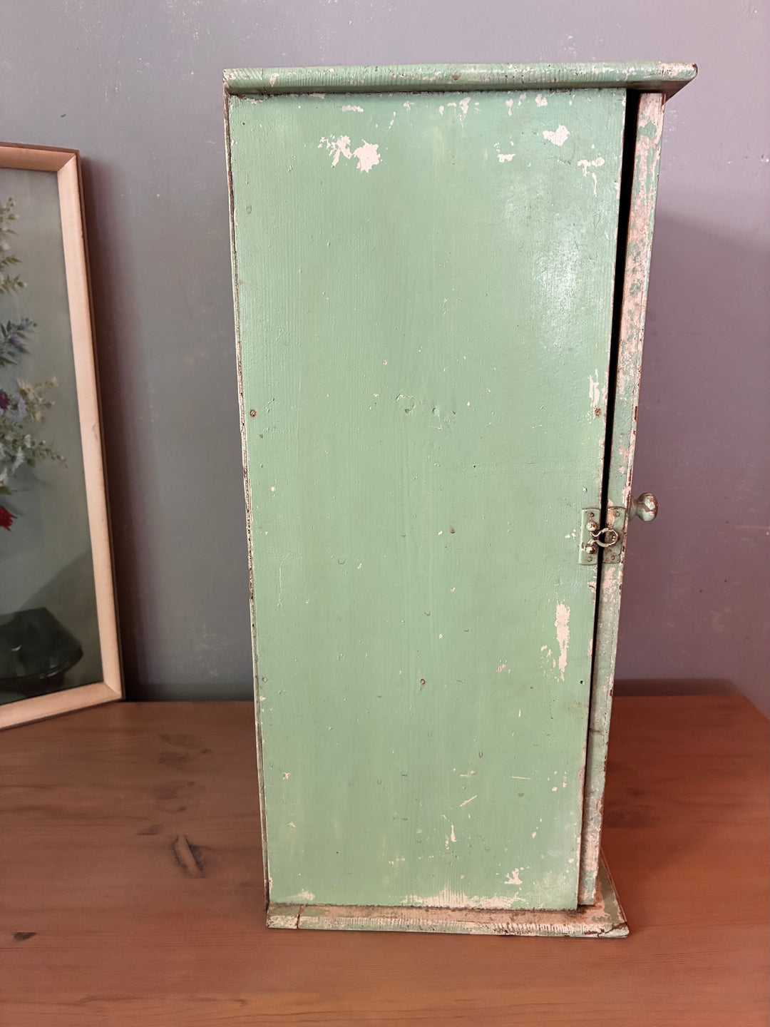Small Green Wooden Cabinet - vintage showcasing its distressed mint green paint and rustic charm.