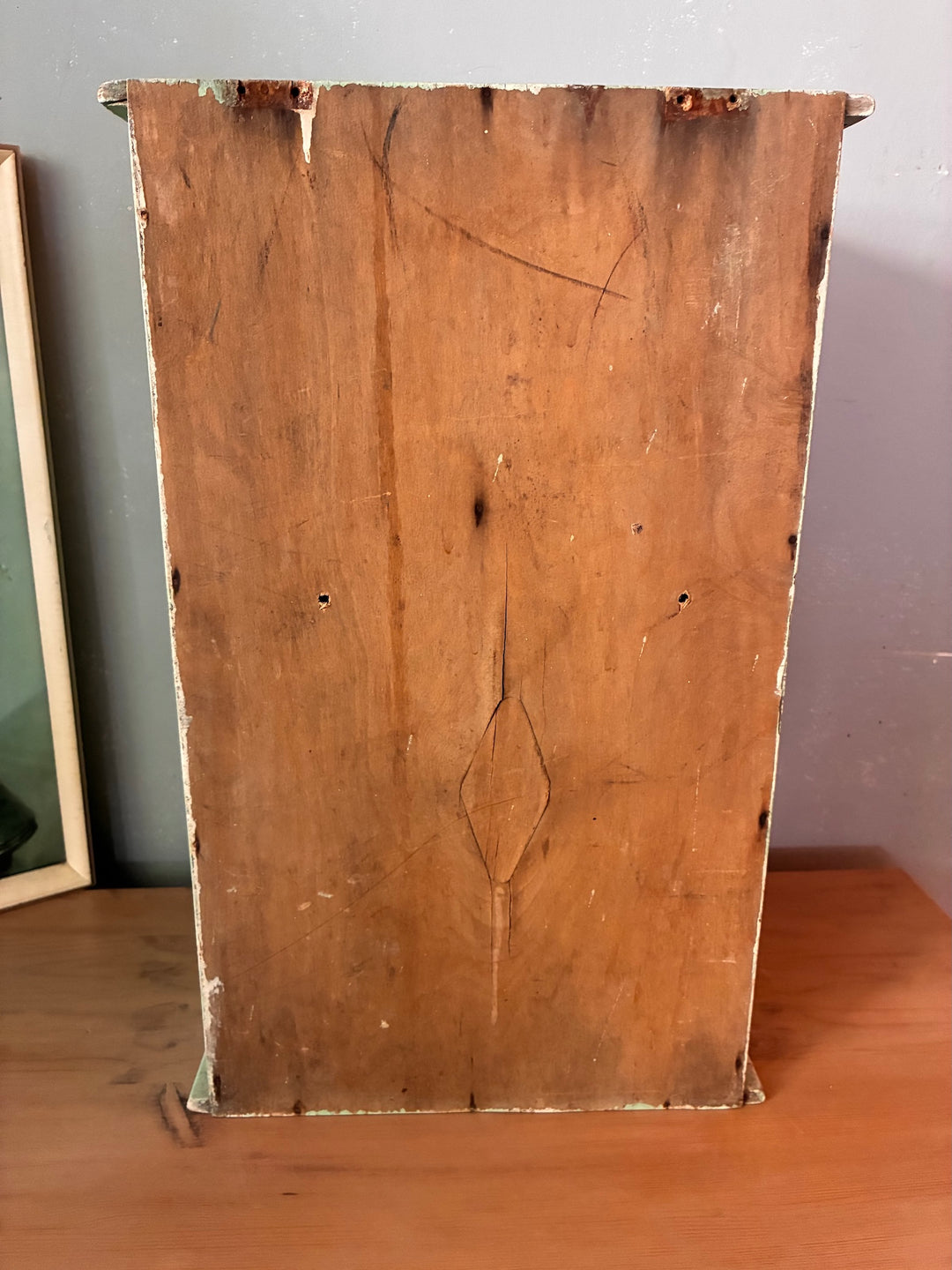 Back view of Small Green Wooden Cabinet - vintage showcasing wood grain and rustic texture.