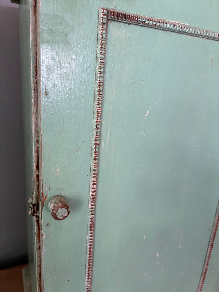 Small Green Wooden Cabinet - vintage with decorative beaded trim and simple wood knob, showcasing rustic appeal.