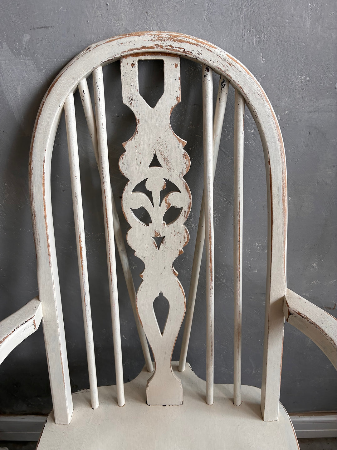 Set of Four Painted Wheelback Carver Chairs featuring a detailed carved wheelback design.
