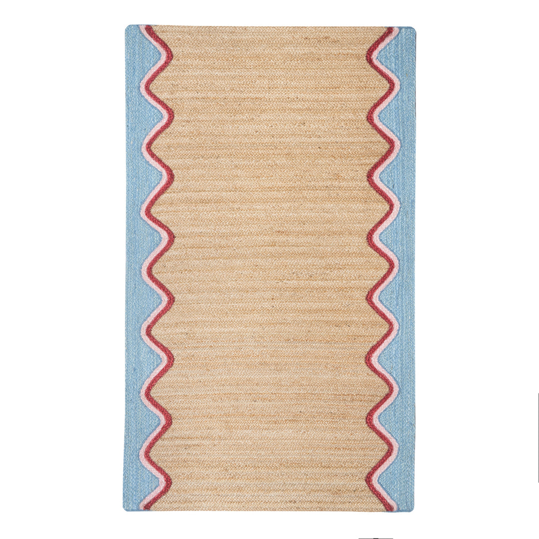Sky Wave Organic Jute Braided Rug featuring a sky blue wave border and soft pink trim, perfect for any home.