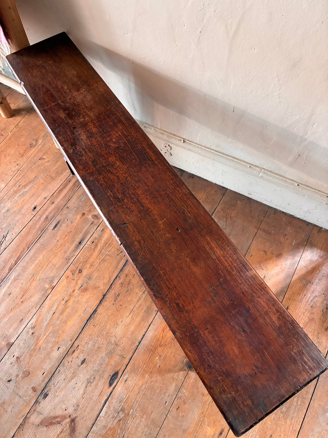 Top view of a Small Antique Pine Bench with a dark brown finish, ideal for storage and seating in small spaces.
