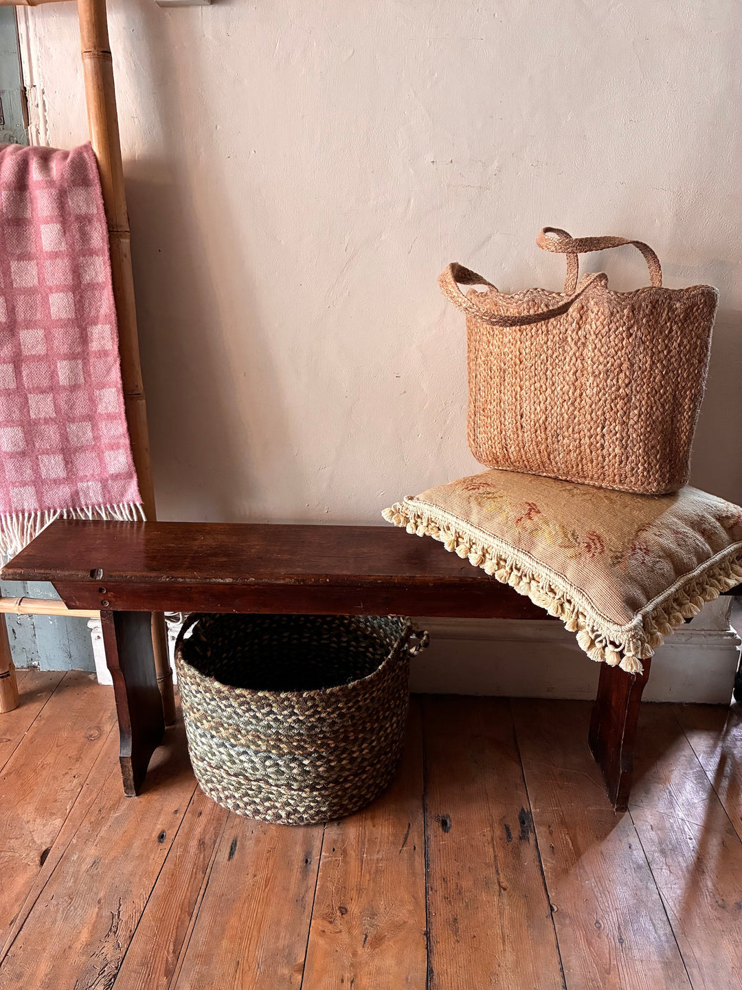Small Antique Pine Bench with pillow and woven baskets, ideal for storage and seating in small spaces, Source for the Goose, Devon.