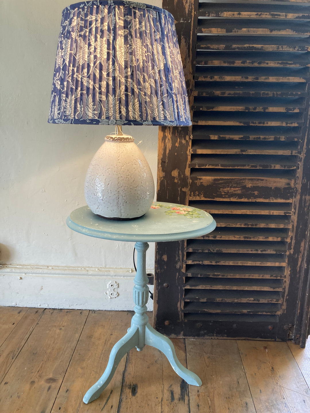 Small Vintage Blue Tripod Table with a ceramic lamp with a blue floral shade on top, for sale at Source for the Goose, Devon