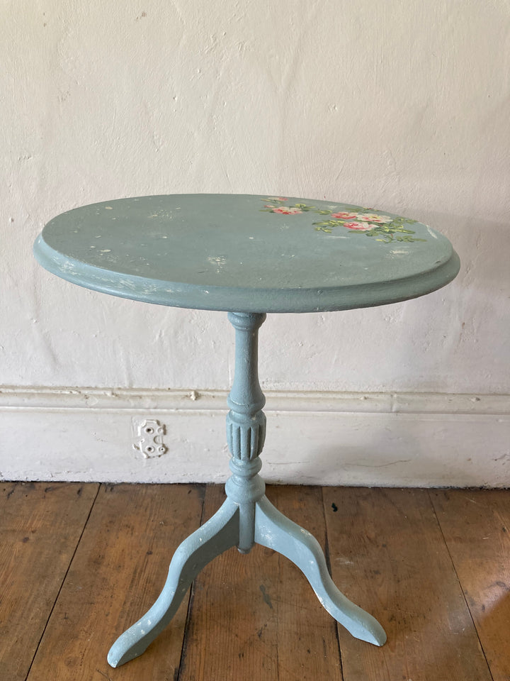 delicate Swedish style table with distressed blue painted finish and painted rose design on the top