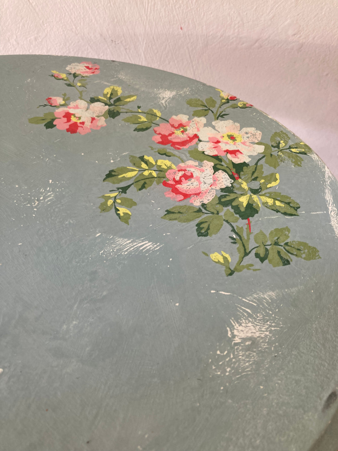close up of painted distressed rose design on Small Vintage Blue Tripod Table