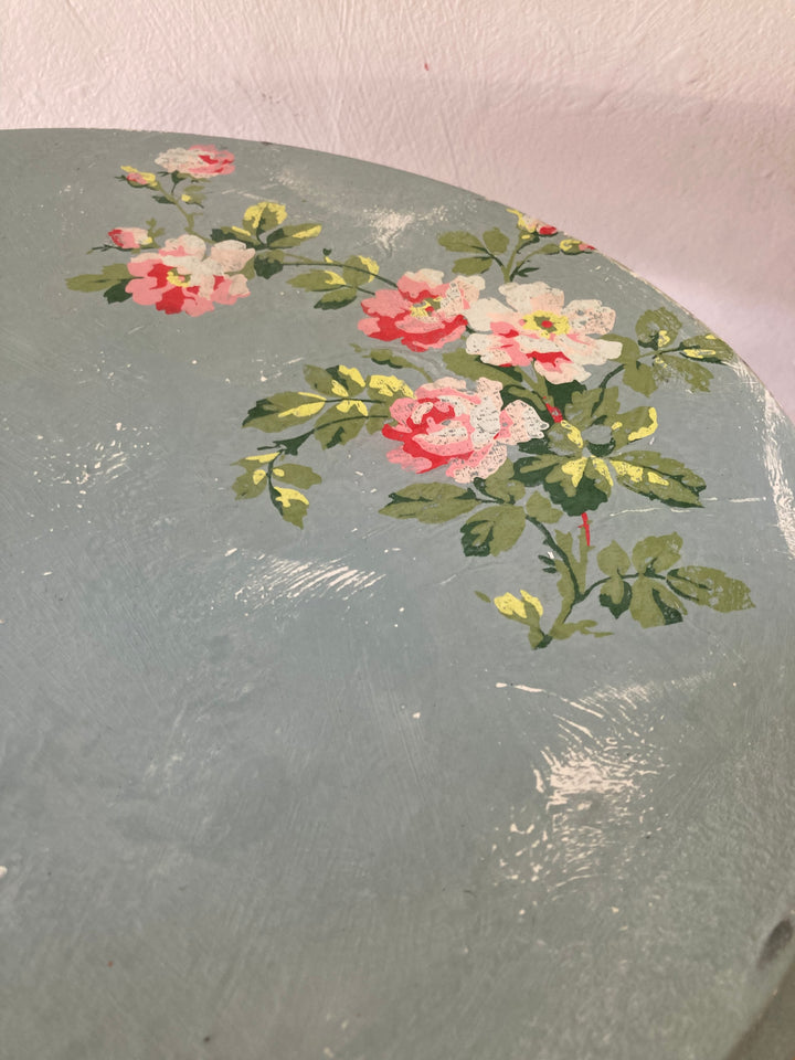 close up of painted distressed rose design on Small Vintage Blue Tripod Table