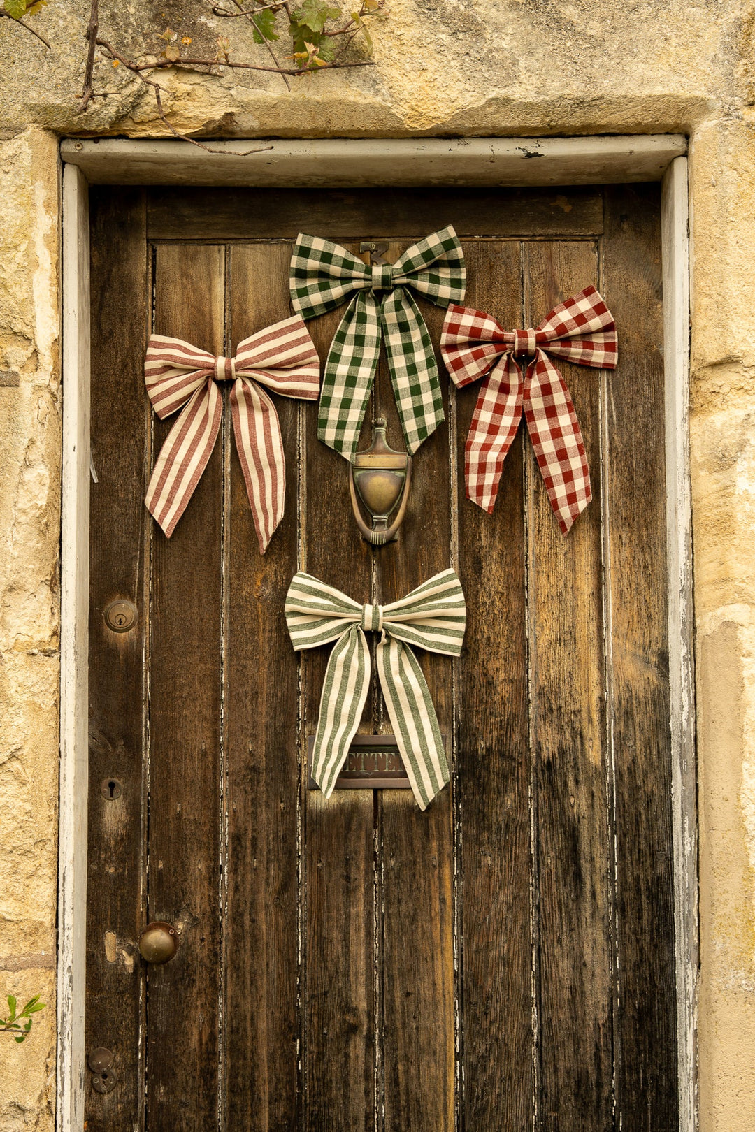 Small Gingham Bow - Two Colours displayed on a rustic wooden door for vintage style cottage core aesthetics.