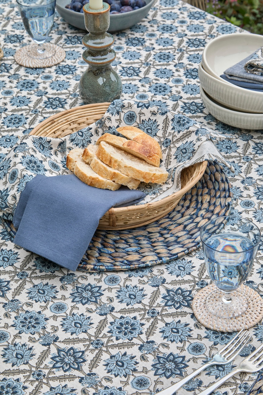 Blue and White Kelmscott Napkin - Set of Four artfully displayed with fresh bread on a beautifully set table.