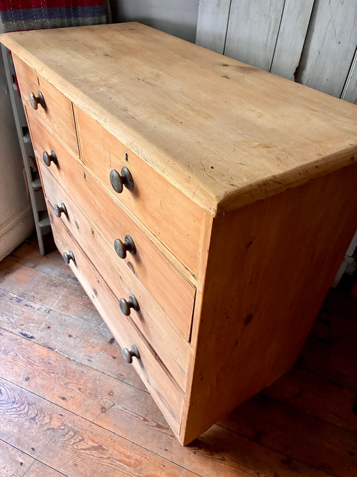 Tall Rustic Antique Pine Chest of Drawers with original knobs and turned feet in a warm finish.