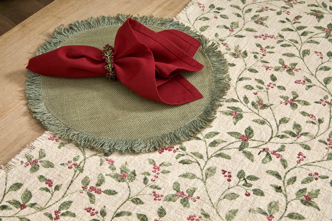 Trailing Berry Christmas Table Runner - Slub Cotton with a red napkin on a green placemat, perfect for holiday dining.