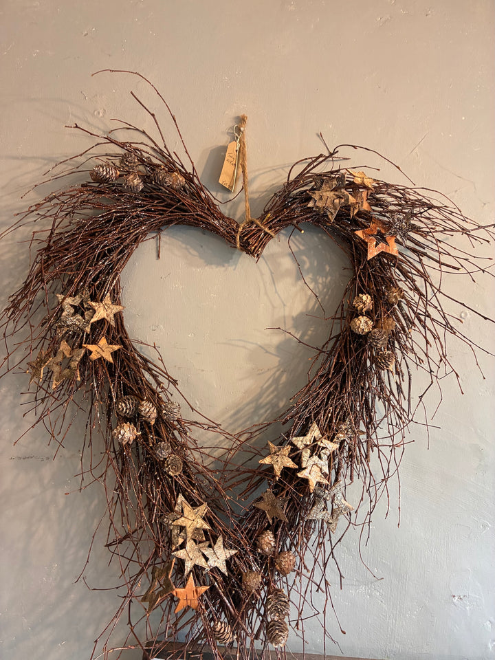 large wreath made from rustic twigs and wooden stars and pine cones at Source for the Goose, devon