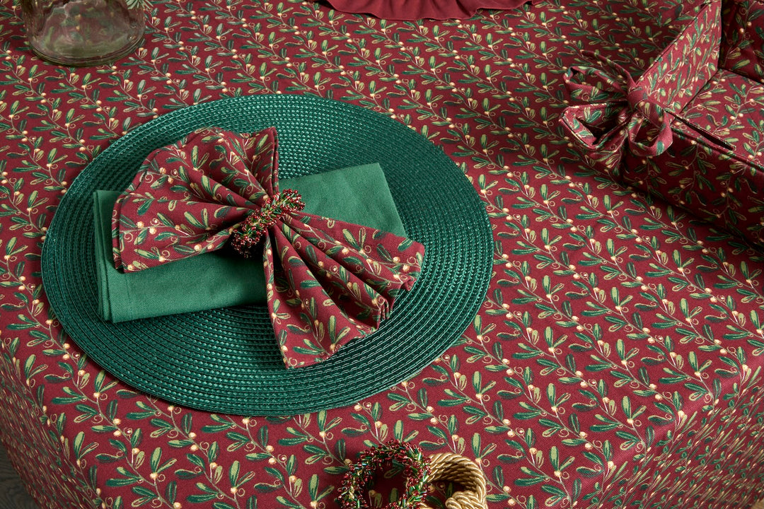 Under The Mistletoe Napkin - Set of Four displayed with festive styling on a holiday table setting.