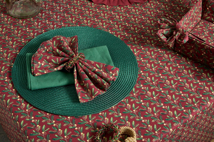 Under The Mistletoe Napkin - Set of Four displayed with festive styling on a holiday table setting.