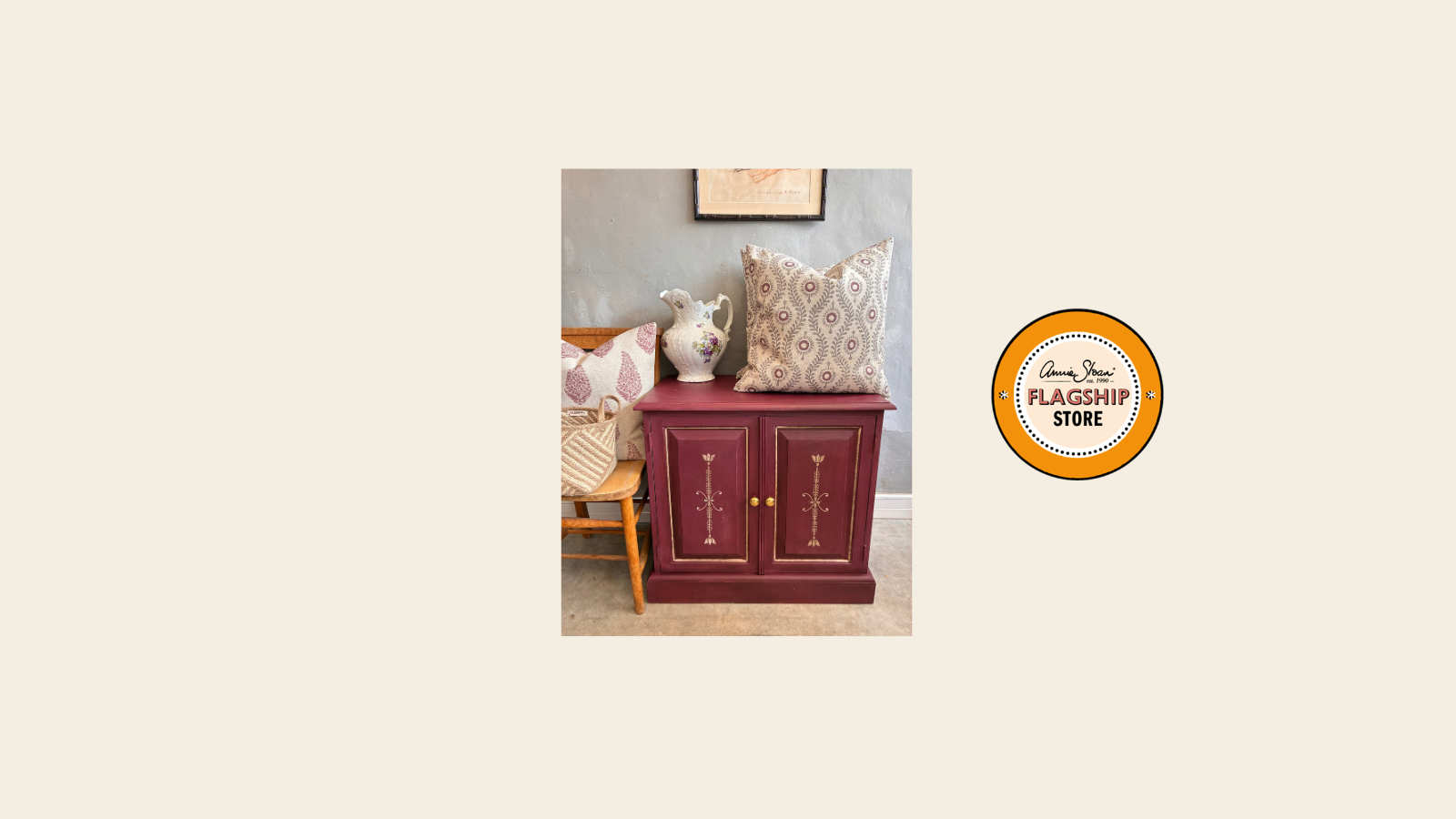 burgundy cabinet with decorative pillows and a jug, with a 'Annie Sloan Flagship Store' logo beside it. 