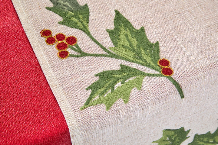 Embroidered Festive Holly Berry Table Runner with lush green leaves and red berries on a textured fabric.