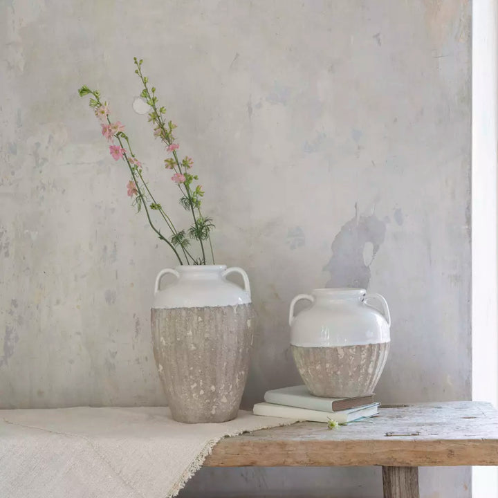 Small Antique White Amphora Vase with pink flowers, showcasing rustic charm and sophistication.