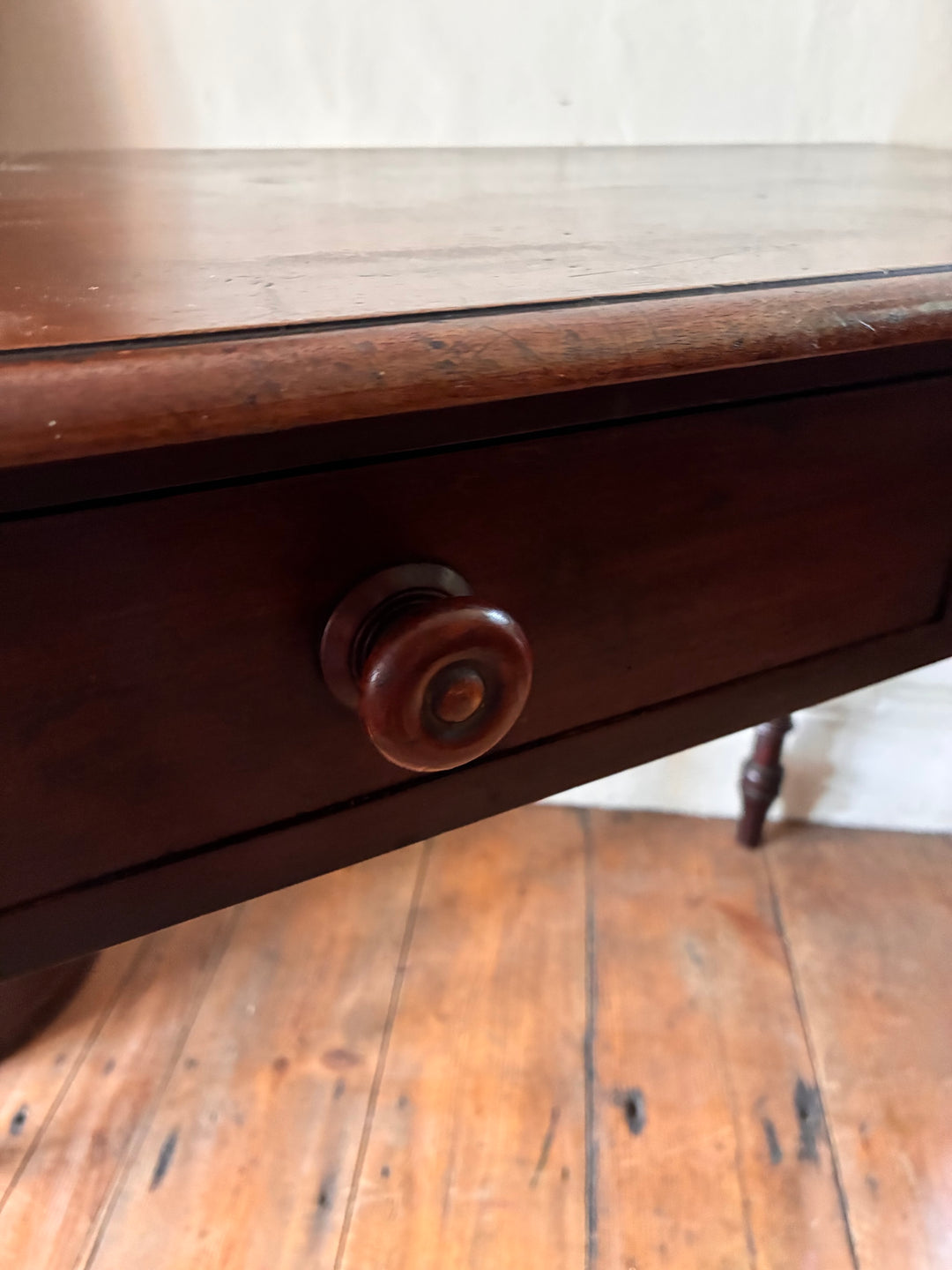 Close-up of Victorian Mahogany Console Table drawer detail, showcasing rich wood finish and classic round knob.
