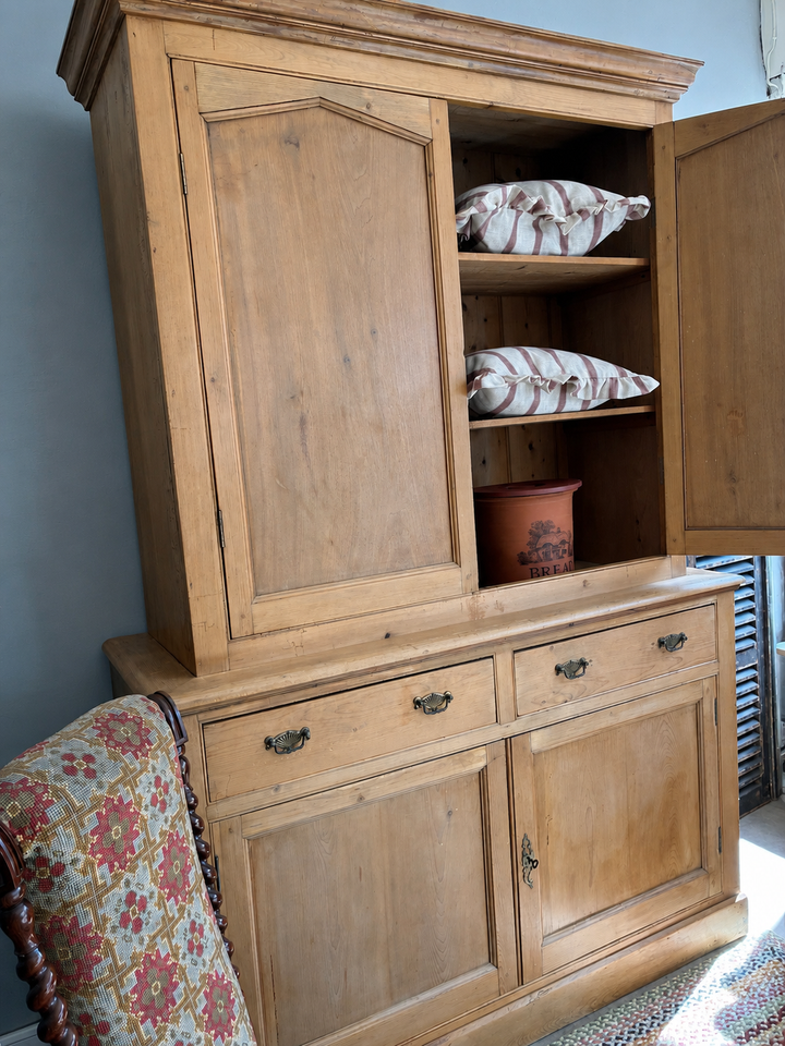 Victorian Pine Housekeepers Cupboard showcasing tall storage with period detailing and original brass escutcheons.