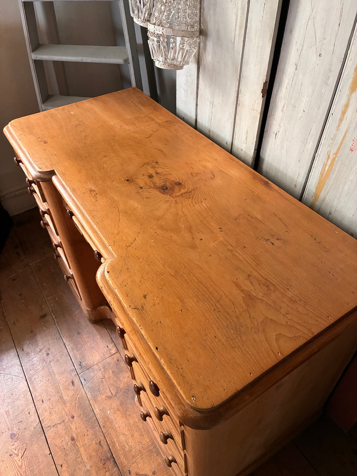 Victorian Antique Pine Pedestal Desk showing a polished wooden top and detailed drawer handles.