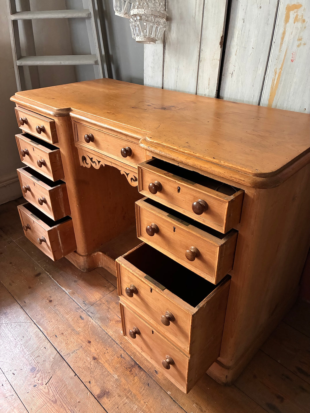 Victorian Antique Pine Pedestal Desk with multiple drawers and a carved panel, showcasing vintage elegance.