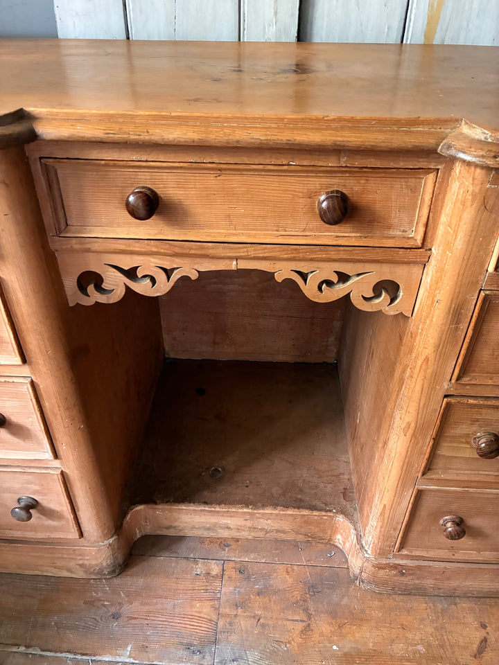 Close-up of the Victorian Antique Pine Pedestal Desk showing the intricate design and central drawer.