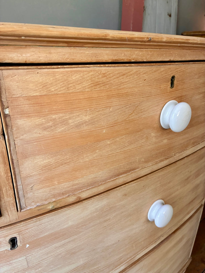 Antique Pine Bow Front Chest of Drawers featuring rustic home design and elegant white porcelain handles.