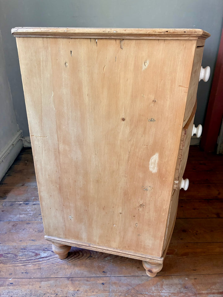 Antique Pine Bow Front Chest of Drawers showcasing rustic home style with pine wood texture and original turned legs.
