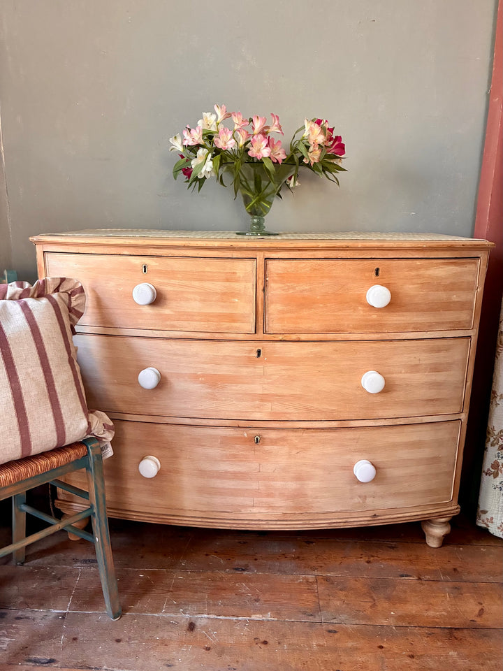 Antique Pine Bow Front Chest of Drawers showcasing rustic home style with elegant white porcelain handles.
