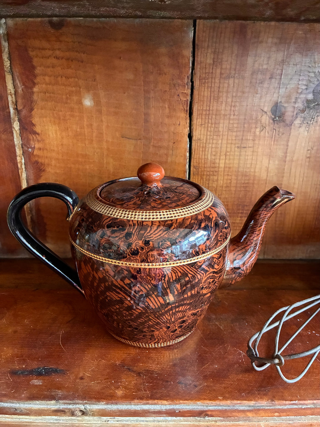 Vintage Oak Ware Design Brown Betty Teapot on wooden shelf, showcasing bark-like pattern and gilt stripes.