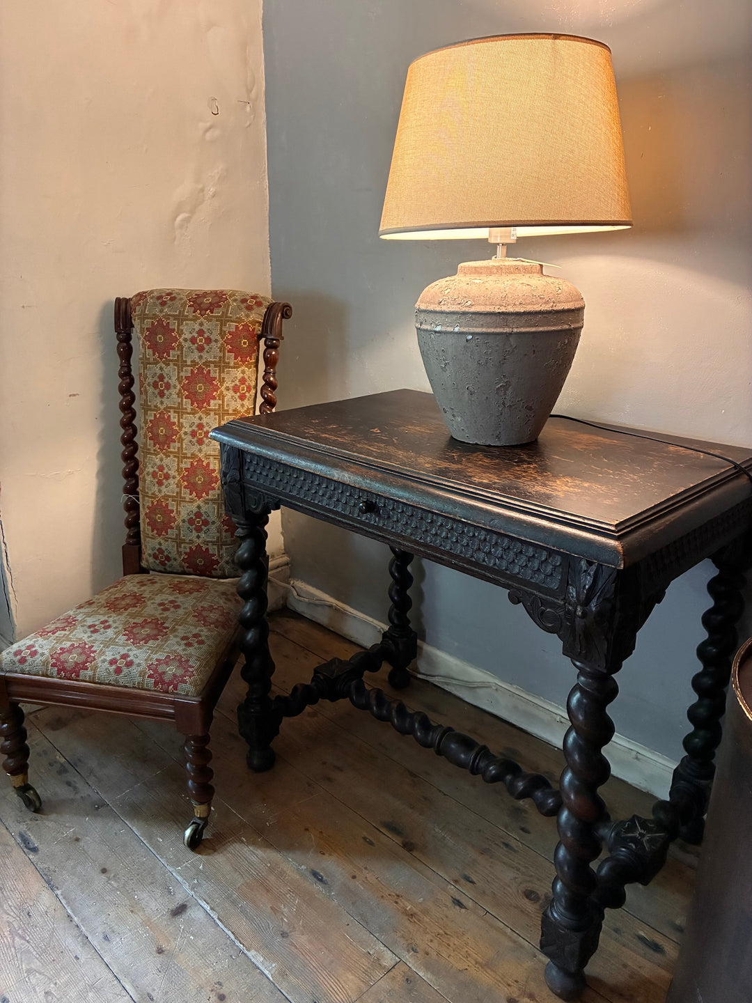 Victorian Oak Table with Barley Twist Legs beside vintage patterned chair and lamp, showcasing exquisite craftsmanship.