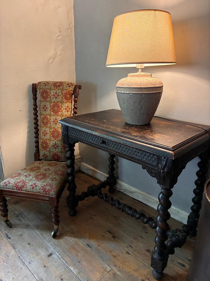 Victorian Oak Table with Barley Twist Legs beside vintage patterned chair and lamp, showcasing exquisite craftsmanship.