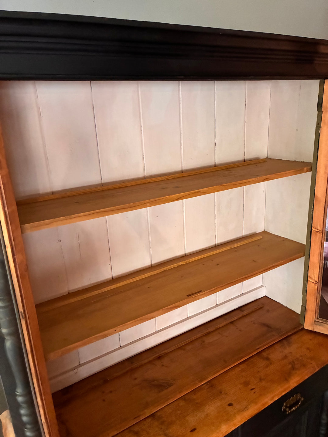Interior view of ebonised Victorian pine dresser showcasing deep wooden shelves, perfect for storage and display.