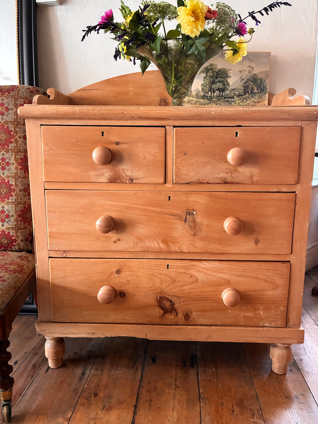 Small Antique Pine Chest of Drawers - Galleried Back with flowers on top, showcasing rustic wood and elegant design.