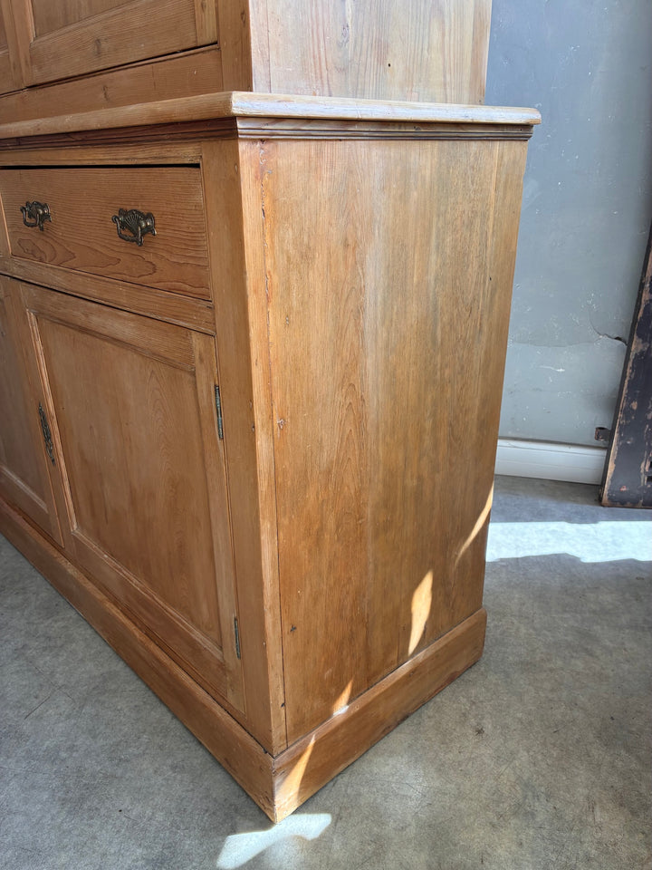 Victorian Pine Housekeepers Cupboard side view showcasing detailed woodwork and brass handles.