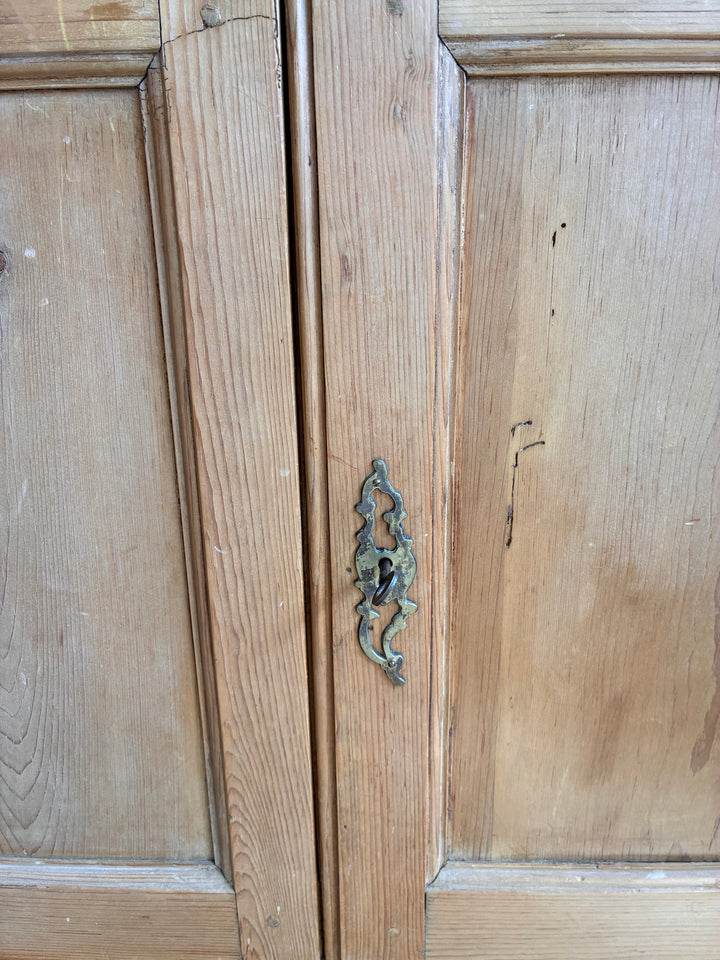 Victorian Pine Housekeepers Cupboard showcasing original brass escutcheons and period wood detailing.