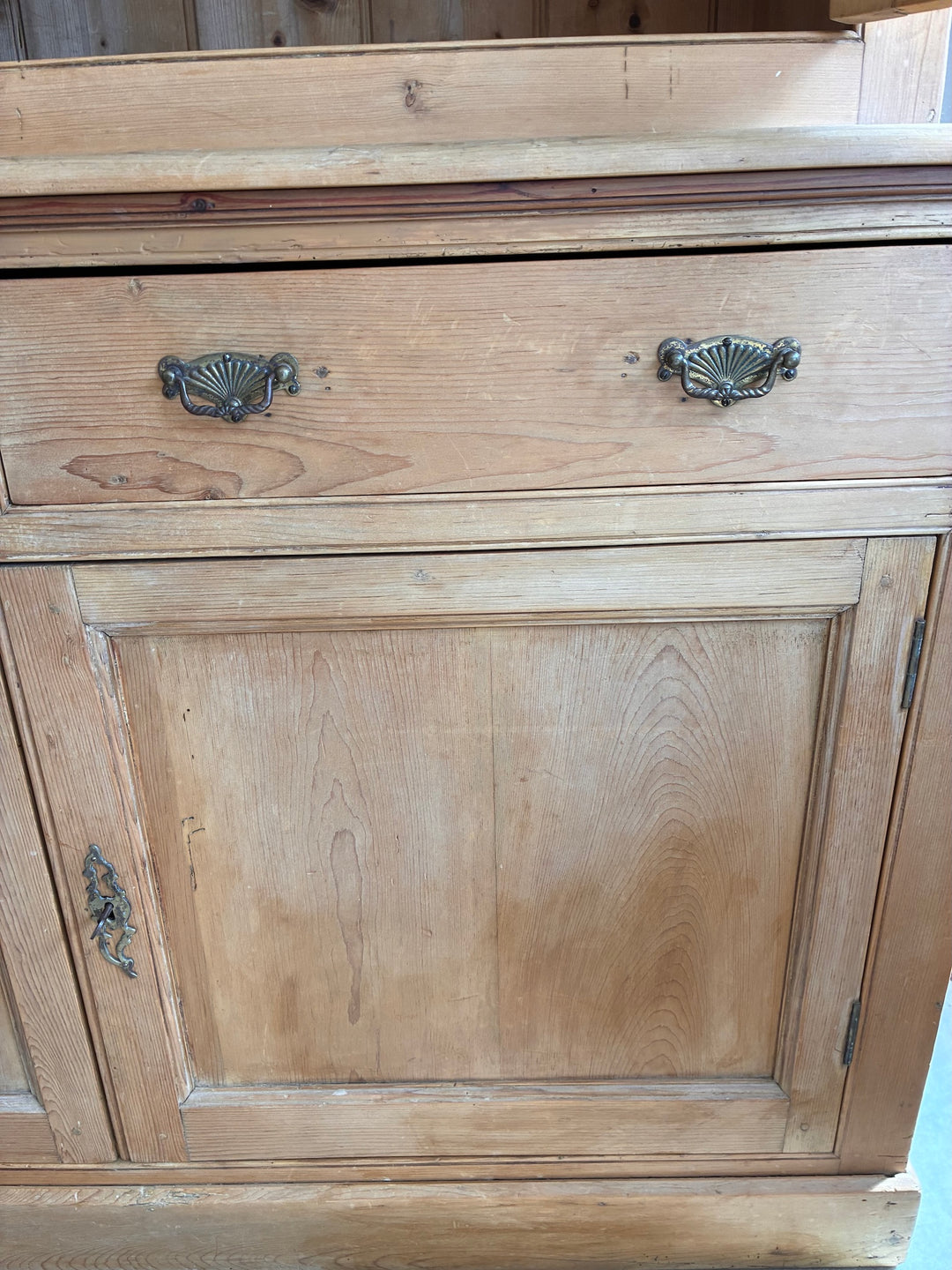 Victorian Pine Housekeepers Cupboard detailed view of brass hardware and wooden surface.